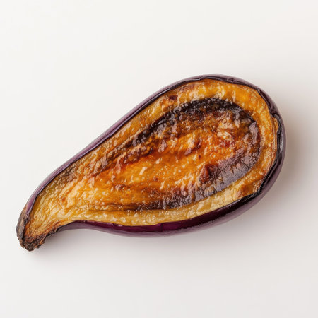 A beautifully roasted slice of eggplant glistens with golden edges, highlighting its soft texture. Perfect for a healthy dish or as a delicious side at dinner time.の素材