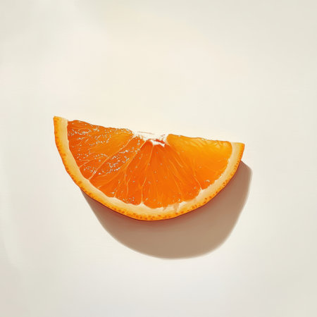 A vibrant slice of orange rests on a clean surface, showing its bright, juicy pulp and contrasting skin, inviting a refreshing taste experience.の素材