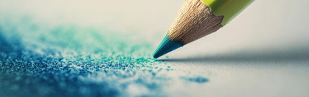 A close-up view captures a blue pencil poised above scattered colored shavings on white paper, evoking a sense of artistic potential and creativity in a calm setting.の素材