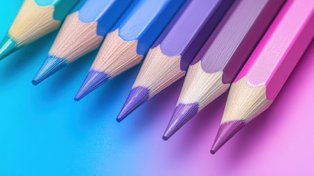 A collection of colored pencils showcases a smooth gradient from blue to pink. Each pencil features a different hue, creating an appealing visual transition of shades.の素材