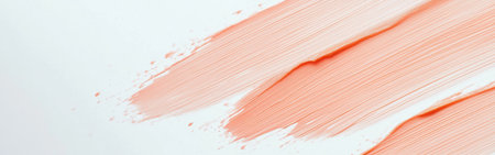 Soft peach brush strokes blend harmoniously on a stark white background, showing the beauty of color and form. This artwork captures a moment of creativity and tranquility.の素材