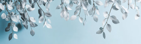 This composition features graceful branches adorned with silver leaves that gently hang against a soft blue background. The delicate appearance creates a calming and tranquil ambiance.の素材