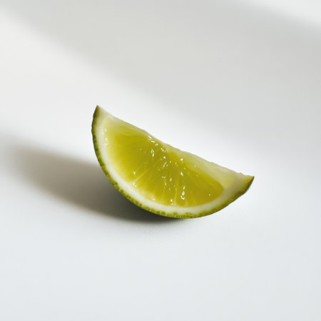 A vibrant lime wedge displays its juicy green flesh, ready to enhance drinks and dishes. Fresh and zesty, it symbolizes tropical flavors and culinary creativity.の素材
