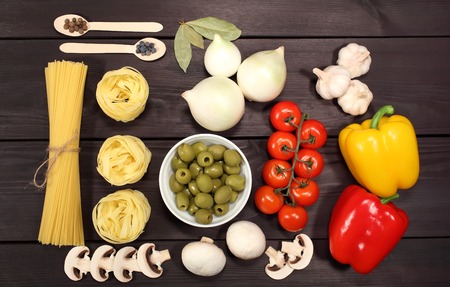 A set of ingredients for cooking pasta for Italian recipe: spaghetti, mushrooms, tomatoes, onions,...