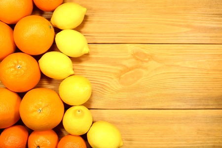 Composition of citrus fruits: oranges, lemons, tangerines, lime and grapefruit on a background of an old rustic table. To design a cooking recipe or menuの写真素材