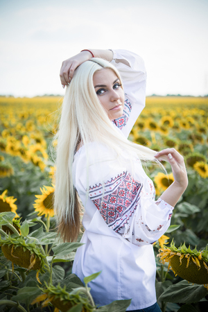 Portrait of the gorgeous young woman in the sunflower fieldの写真素材