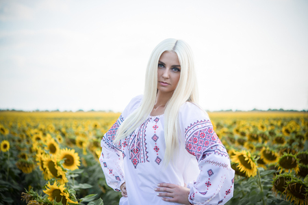 Portrait of the gorgeous young woman in the sunflower fieldの写真素材