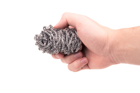 sponge for dishes in a hand on a white backgroundの写真素材