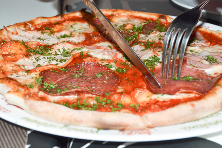sliced pizza on the plateの写真素材
