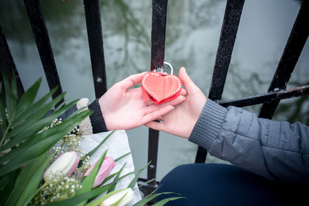the bride and groom hold the lock in the form of heartの写真素材