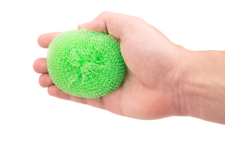 sponge for dishes in a hand on a white backgroundの写真素材