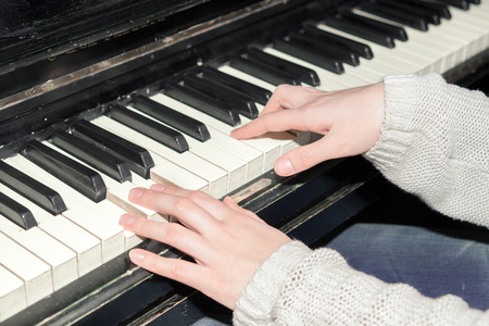 a young girl playing the pianoの写真素材