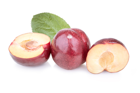 Three plums with leaves on white backgroundの写真素材