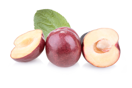 Three plums with leaves on white backgroundの写真素材