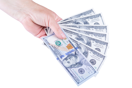 Woman's hand holding money isolated on white backgroundの写真素材