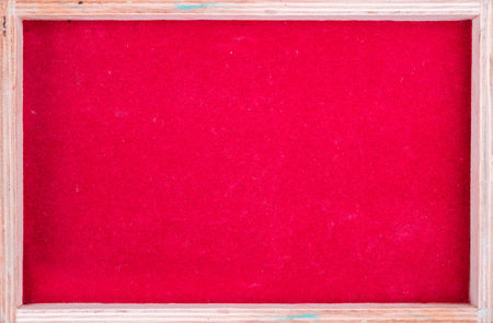 Wooden rectangular picture frame with red backgroundの写真素材