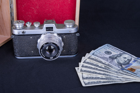 hundred dollar bills with a cameraの写真素材
