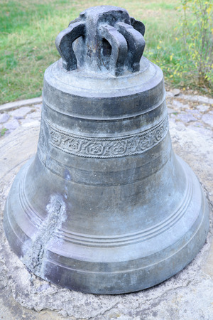 Old church bell on the groundの写真素材