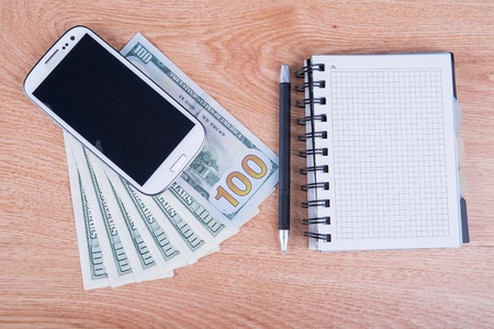 one hundred dollars on a wooden backgroundの写真素材