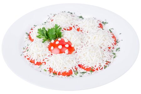 An isolated sliced tomato in grated cheese. Decorated with parsleyの写真素材