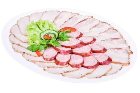 Isolated cutting of meat and sausage decorated with greensの写真素材