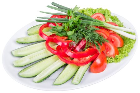 Sliced appetizer on a plate of cucumbers, tomato, pepper, onion, parsley, dill and lettuceの写真素材