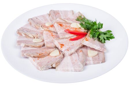 An isolated plate of sliced baked meat with garlic. Decorated with dill, parsley, pepper slicesの写真素材