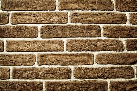 background of a light brown brick wall with white seams