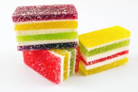 Sliced â€‹â€‹multicolored marmalade on a light background