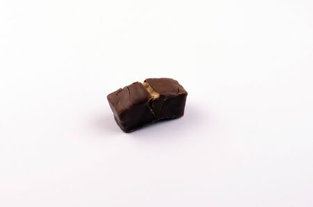 chocolate candies with nuts and caramel on a white backgroundの写真素材