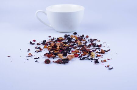 Fruit tea with a cup on a light background. Tea textureの写真素材