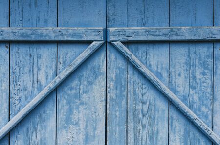 Old wooden gate in blue colorの写真素材
