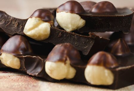 Whole hazelnut in dark chocolate close up