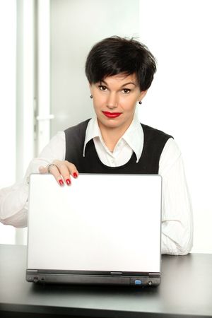 Beautiful business woman closing a laptopの写真素材