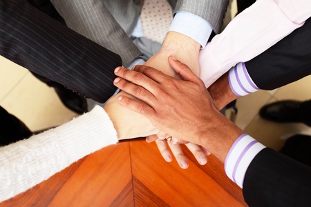 Image of business people hands on top of each other. View from aboveの写真素材