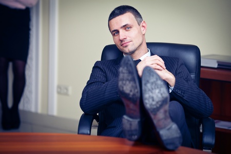businessman relaxing at the office with his shoes on the desk の写真素材