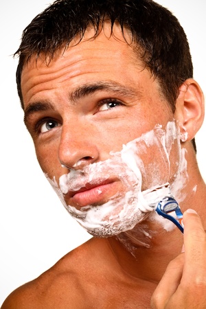 Sexy handsome young man with a shaving foamの写真素材