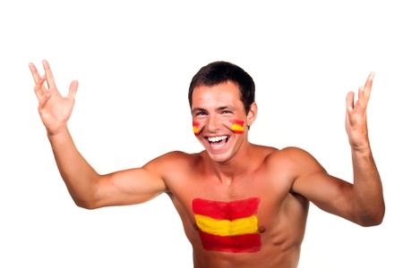 Cheerful happy spanish football fan with flag on his body and face, isolated on whiteの写真素材