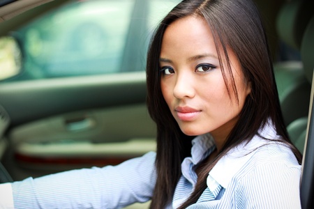 beautiful brunette asian businesswoman in a carの写真素材