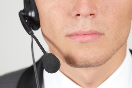 Closeup of operator's mouth and a microphoneの写真素材