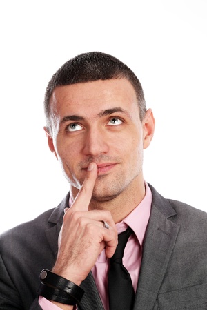 Handsome young business dreamy man isolated against whiteの写真素材