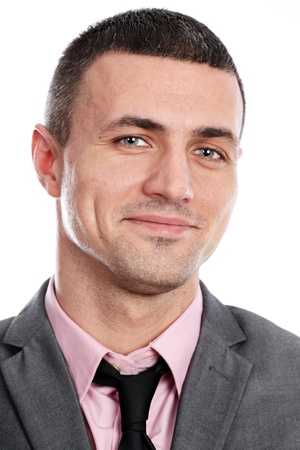 Portrait of a handsome young happy businessman in suit over white backgroundの写真素材