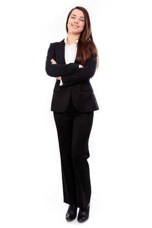 Confident business woman standing full length in black suit, isolated on white backgroundの写真素材