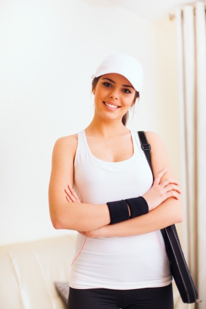 Young happy woman with tennis bag is ready for game の写真素材