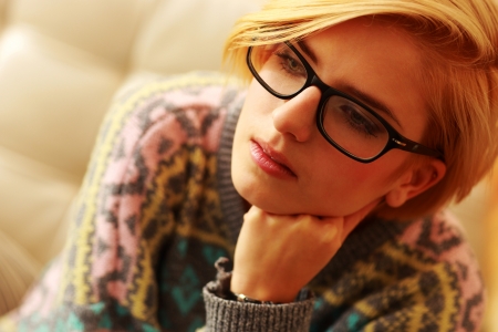 Closeup portrait of a young thoughtful woman in glasses の写真素材