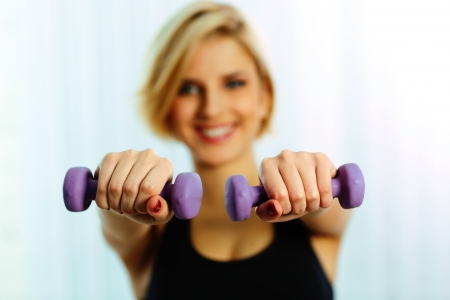 Closeup image of female hands holding dumbbellsの写真素材