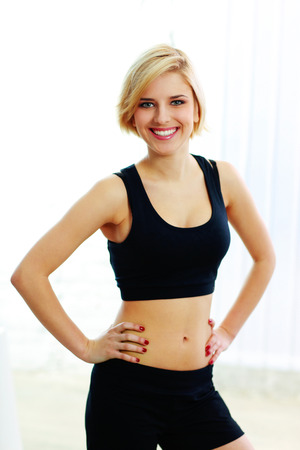 Young smiling fit woman in black sports braの写真素材