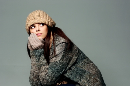 Young thoughtful woman in warm winter outfitの写真素材