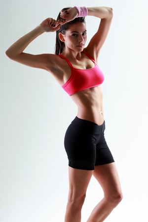 Young beautiful woman standing on gray backgroundの写真素材