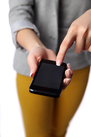 Woman pointing at smartphone screen isolated on a white backgroundの写真素材